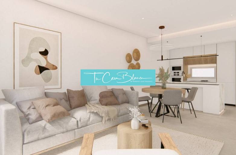 Living room in a holiday apartment with a kitchenette and a floor with a wooden decor.