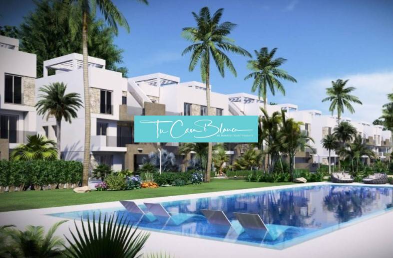 A recreational apartment in Guardamar del Segura with a pool, palm trees, and modern apartments in the background.