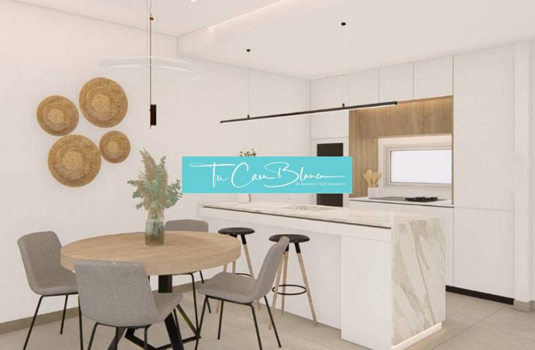 A kitchen in a holiday apartment with a dining table and minimalist wall decor.
