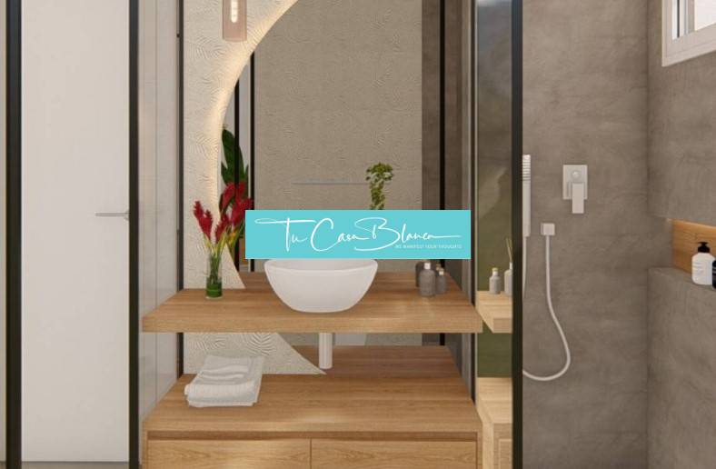 A bathroom in a holiday apartment with a sink on a wooden countertop and a shower.