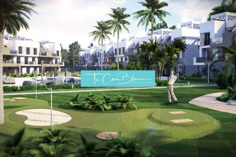 A holiday apartment in Guardamar del Segura with a view of the golf course surrounded by palm trees.