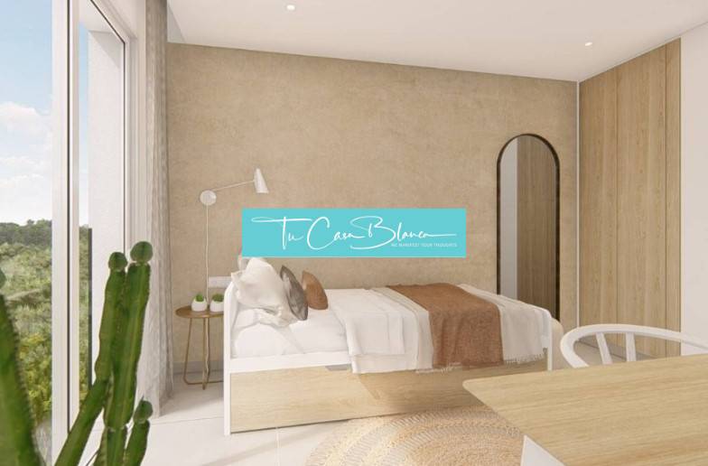 Bright bedroom with a bed, large window, and wood-patterned floor in a holiday apartment.