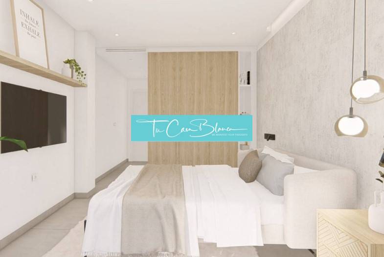 Bright bedroom with decor, TV, and modern furniture in a holiday apartment.