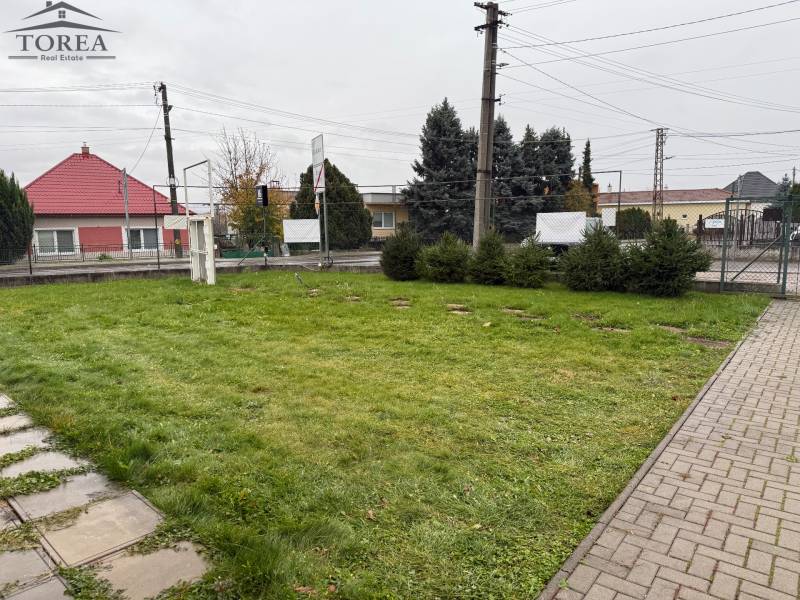 Land with a lawn in Dolné Chlebany on Dolné Chlebany Street near commercial spaces.