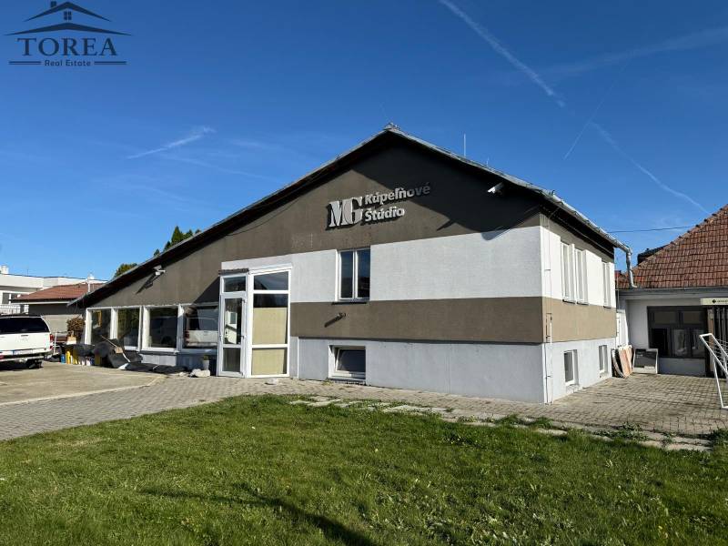 The commercial spaces in Dolné Chlebany stand out with large windows and a modern facade.