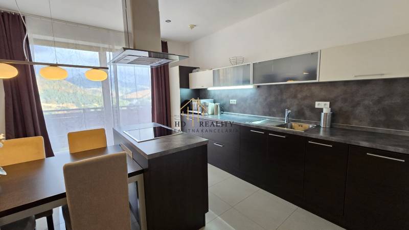Stylish kitchen in a 3-room apartment with a dining table, view, and modern appliances.