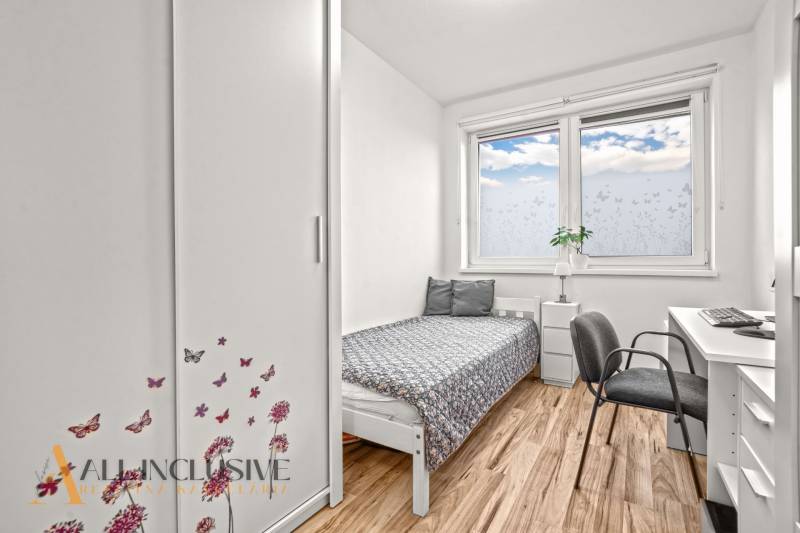 Children's room with a bed, wardrobe, and desk. Floor with wooden decor.