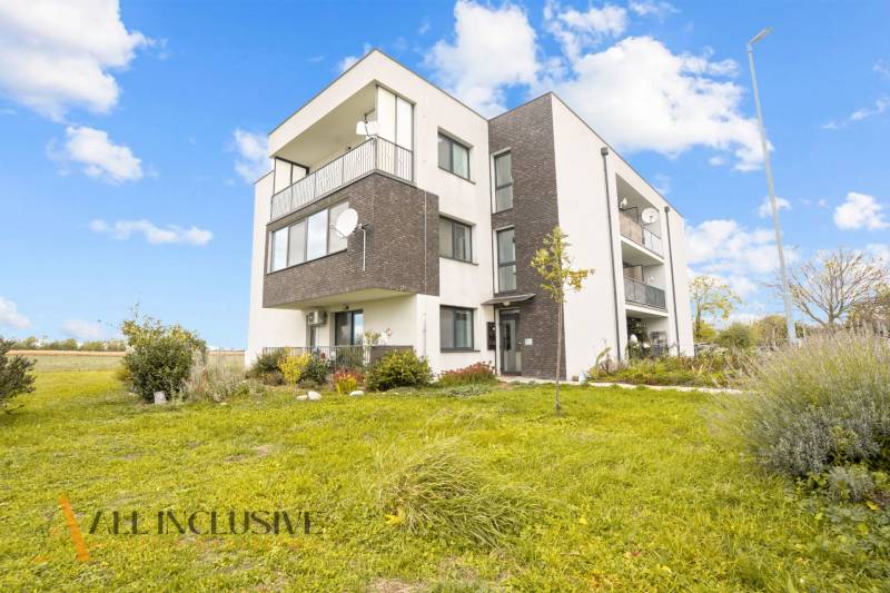An apartment building surrounded by greenery in Blatná na Ostrove, including space for a 3-room apartment.