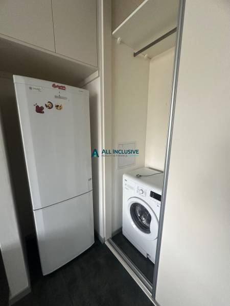 Two-room apartment with a refrigerator and washing machine, built-in wardrobe with sliding doors.