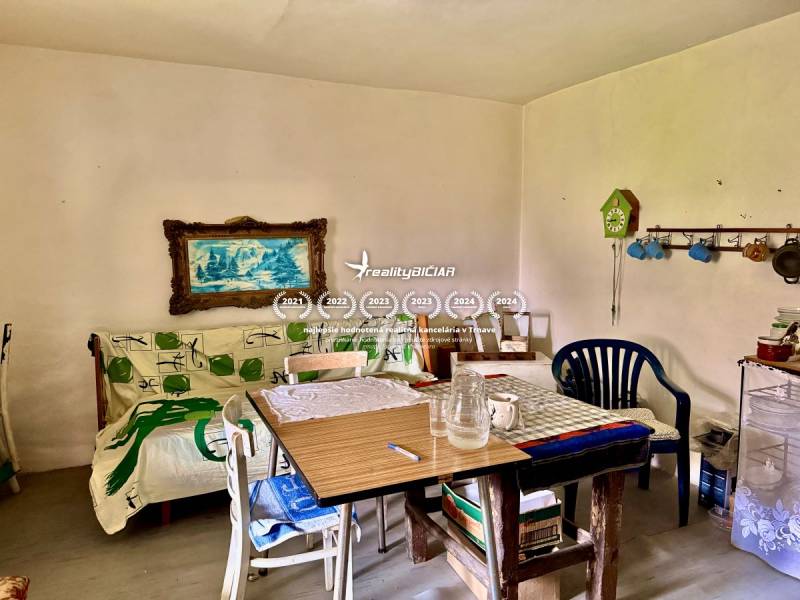 A dining room in a family house with colorful decorations and a painting on the wall.