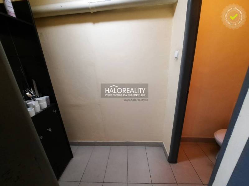 Offices with equipment and a toilet in the business. Cabinet with glasses, light floor.