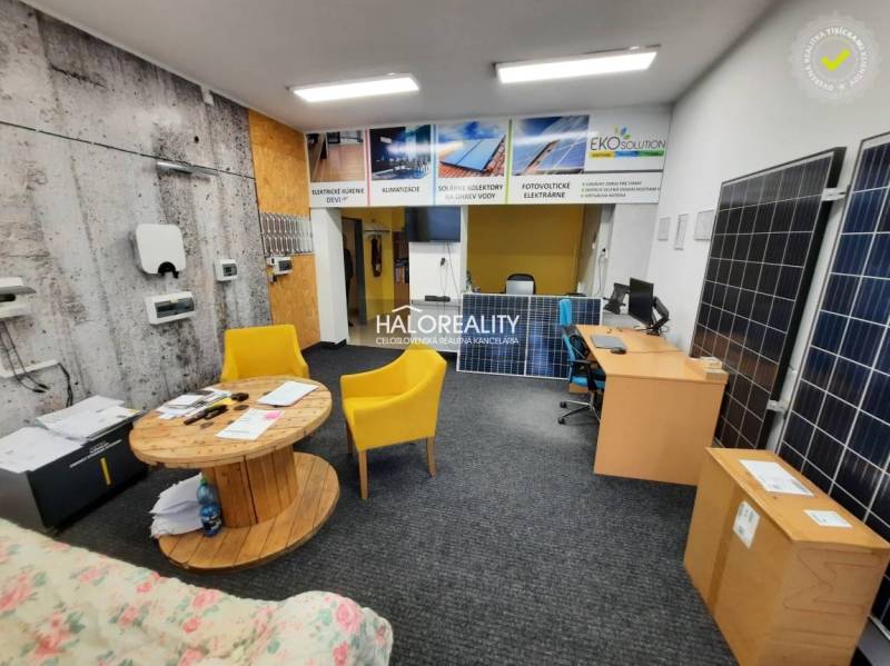 Offices with exposed solar panels, wooden elements, and yellow chairs.