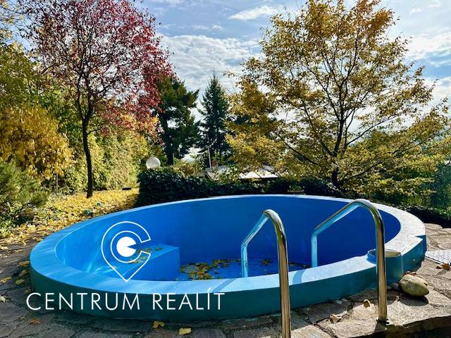 A swimming pool surrounded by autumn trees on a residential property in Bratislava, Karlova Ves on Hany Meličkovej.