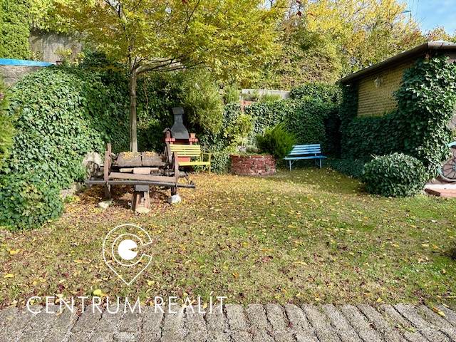 A garden with a lawn and seating area on a residential property in Karlova Ves on Hany Meličkovej.