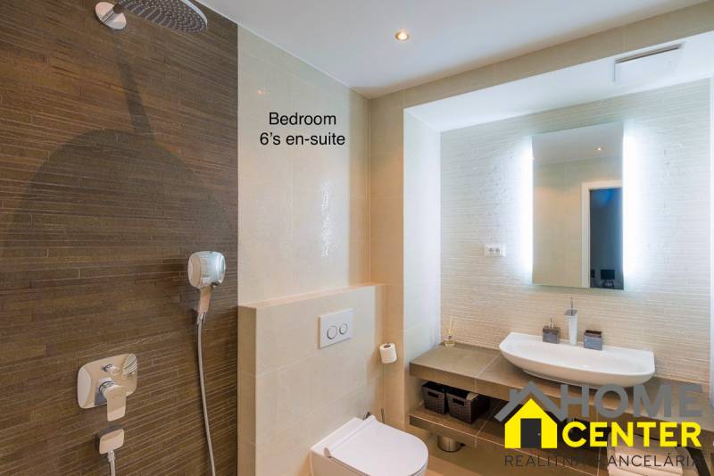 Bathroom in a villa with a shower and a sink, elegant interior.