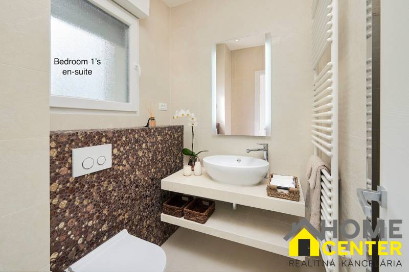 Bathroom in the villa with a stylish sink and decorative tiles.