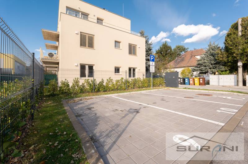 Parking lot near a two-story building on Železničná Street in Bratislava, Vrakuňa.