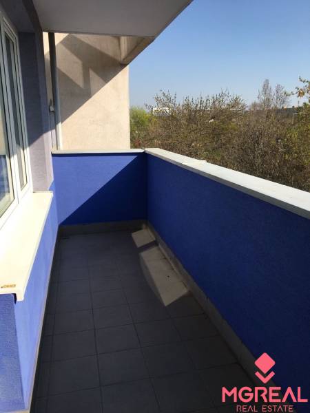 A balcony in a 1-room apartment on Tomášikova Street in Bratislava - Ružinov with a blue wall.