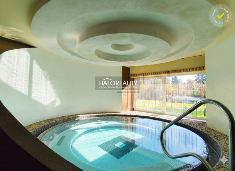 Interior dining spaces with a pool and garden view.