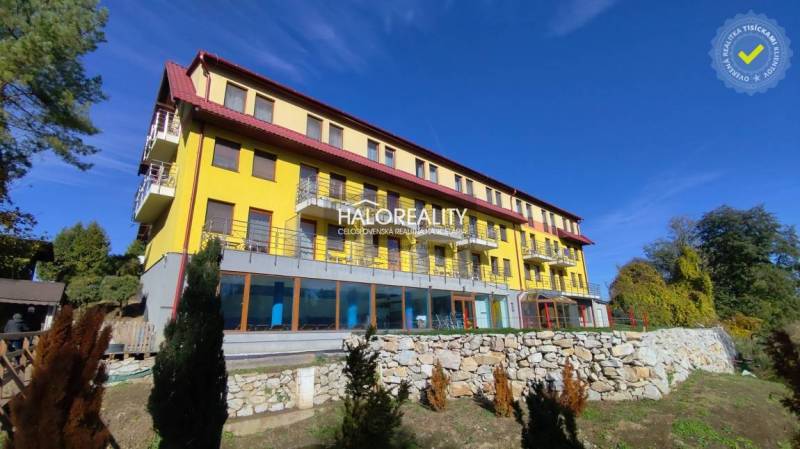 Yellow building with balconies, surrounded by greenery in Dudince, Gastro premises.