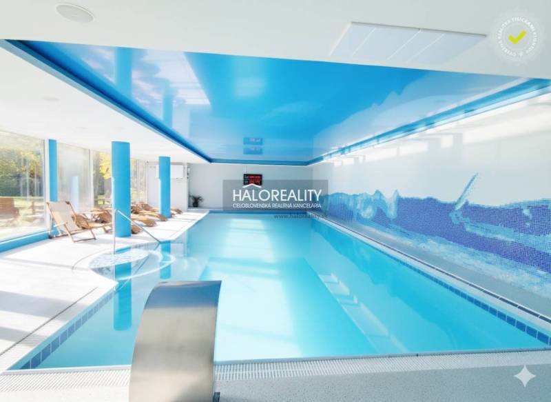 A pool with blue ceilings and loungers in indoor dining areas.