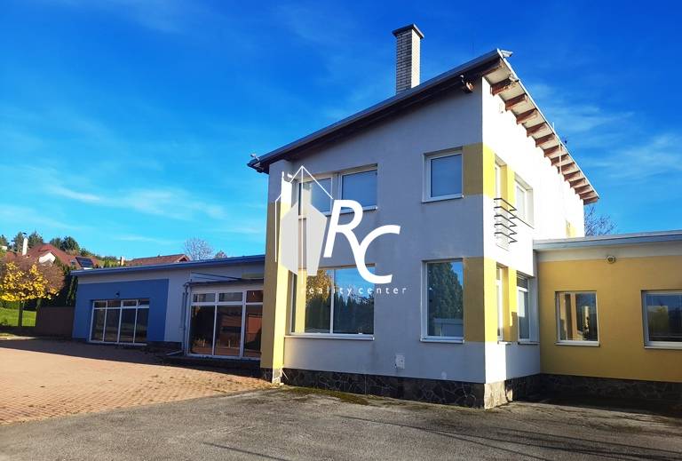 A family house in Necpaly, colorful facade, large yard, sunny bright day.