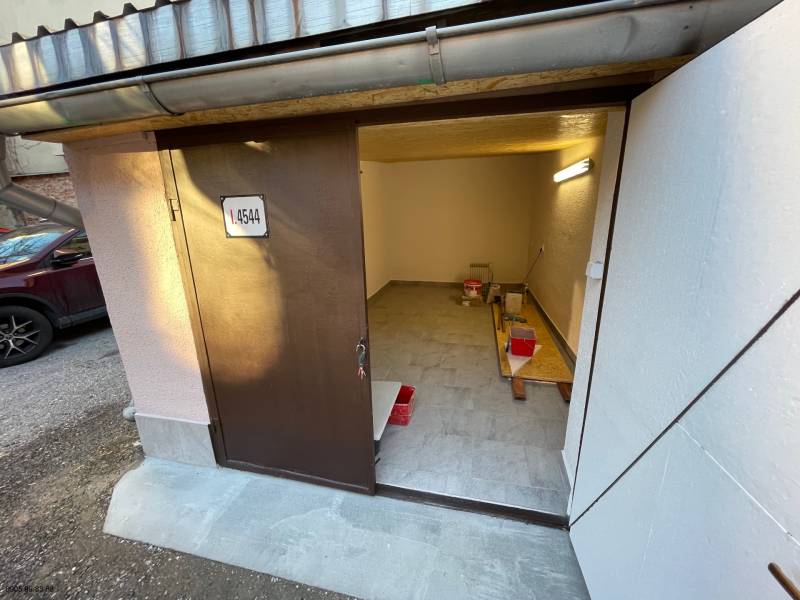 An open garage on Mlynská in Košice - Staré Mesto district, with tools and a bucket.