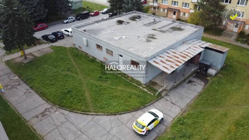 Commercial premises in Rimavská Sobota with surrounding greenery and parking lot.