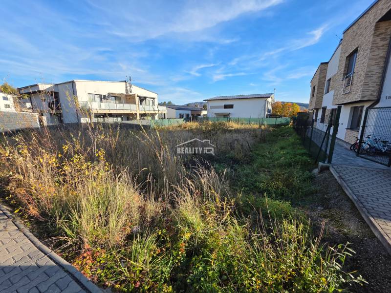 Residential land in Bytča with buildings and paved area.