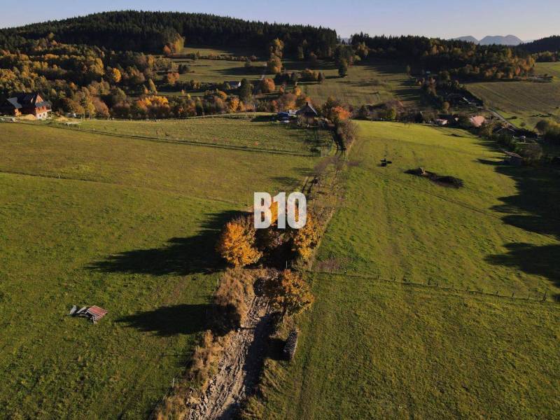 Greenery and meadows in Pozemky - living in Petrovce, surrounded by trees and hills.