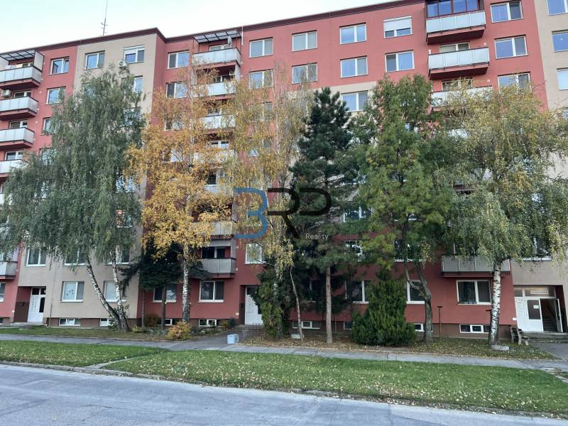 Apartment building on Hviezdoslavova Street in Senica with surrounding greenery and trees.