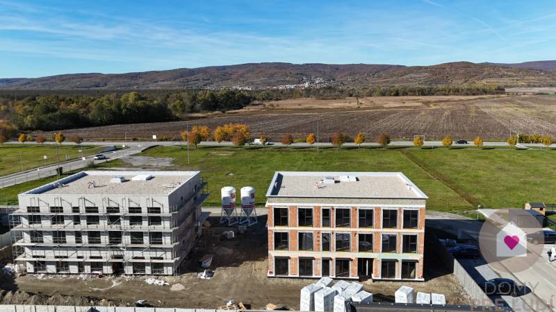 Construction project on Dúhová Street in Slovenský Grob, surrounded by nature and open countryside.