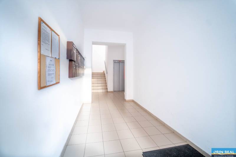 Apartment entrance with mailboxes and elevator, suitable for a 2-room apartment.