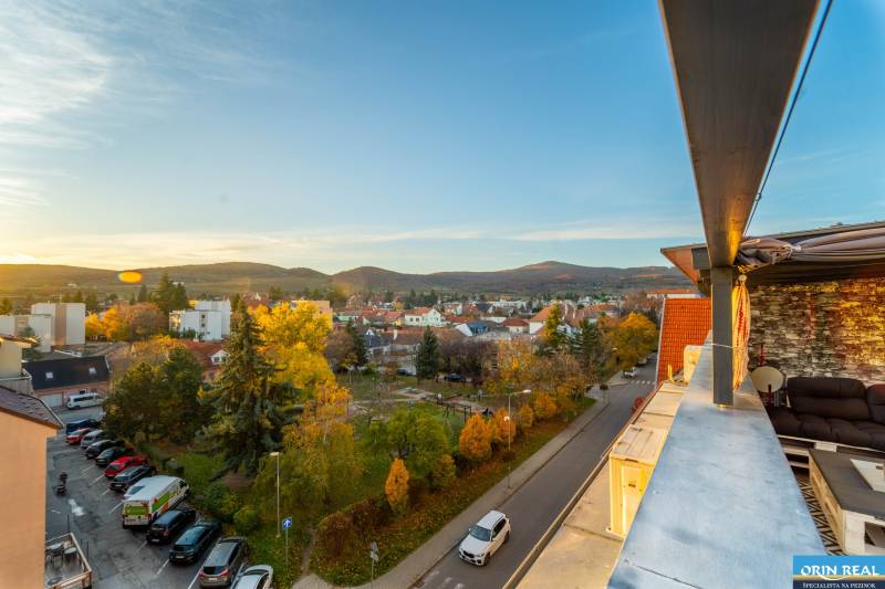 View from Vajanského Street in Modra of the surrounding landscape and residential buildings.