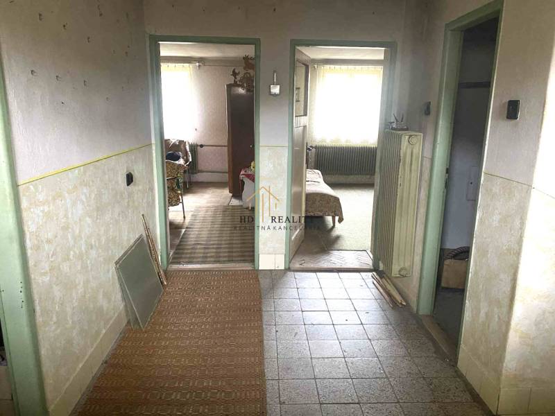 Interior of a family house with a hallway and entrances to rooms, floor with wood decor.