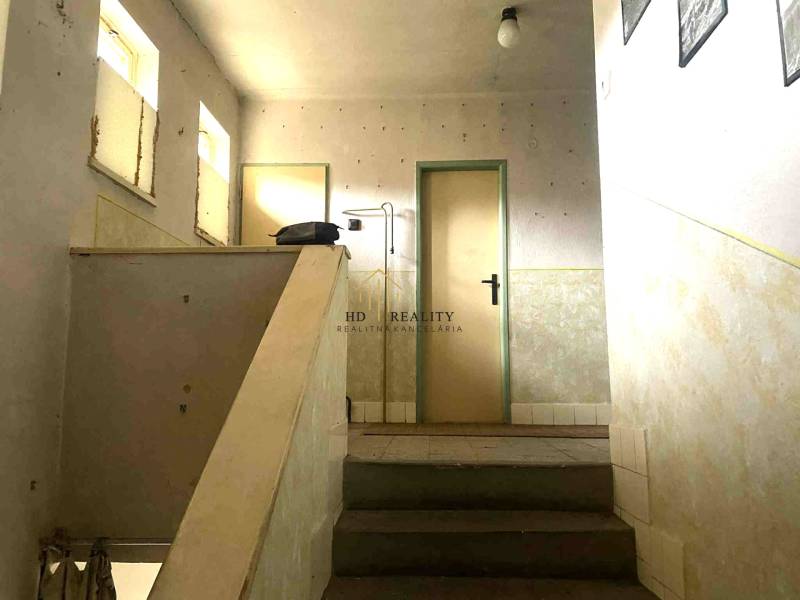A simple staircase in a family house with a minimalist interior and light walls.