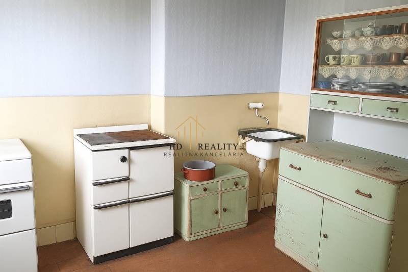 A kitchen in a family house with retro furniture and a sink.