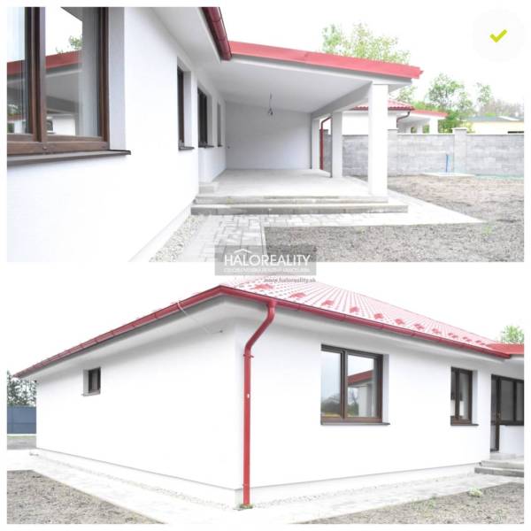 The family house in Závod features a white facade with a red roof and a canopy.