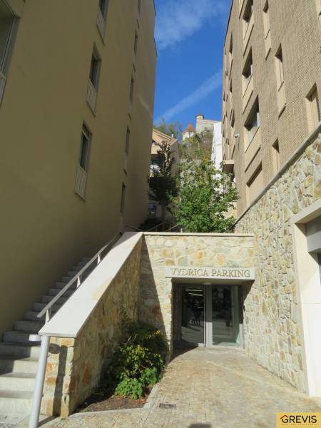 Outside in Bratislava on Floriánska, there is an entrance to a parking lot.