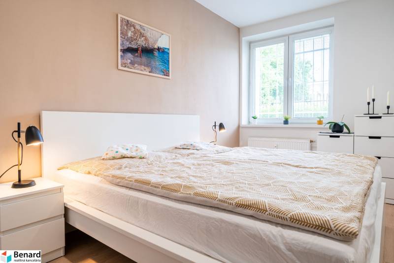 Bedroom in a 3-room apartment with a large bed, table lamps, and a bright interior.