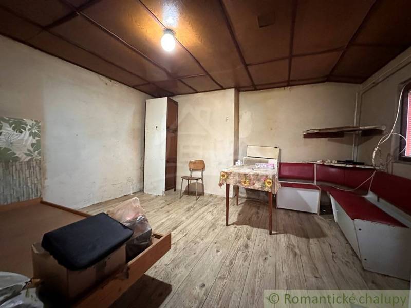 Interior of a family house with a bench and table, floor with wooden decor.