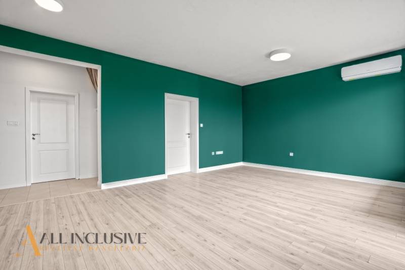 A room with a wooden floor design, green walls, and air conditioning, 2-room apartment.