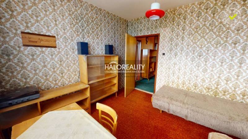 Interior of a 3-room apartment with retro wallpapers, furniture, and a red lamp.