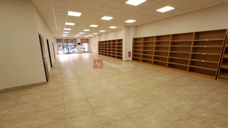 Commercial premises for rent on Mostová Street in Ružomberok, with shelves and flooring with a wooden decor.