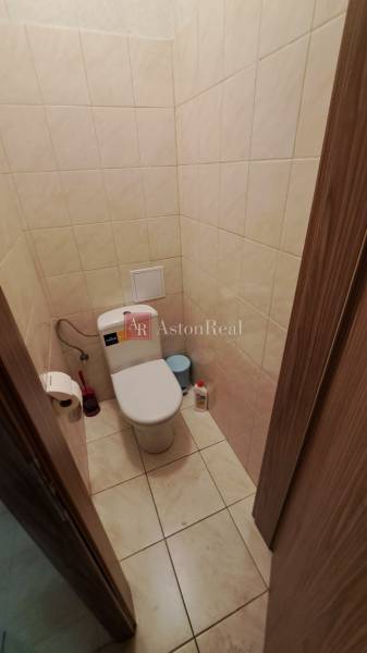 Bathroom commercial premises with tiles, toilet, and accessories.