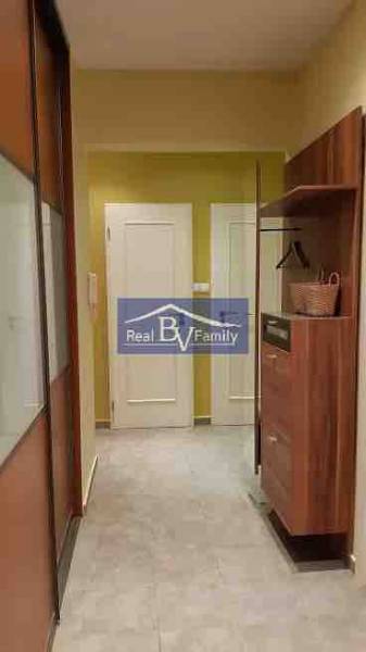 A hallway in a 2-room apartment with storage space and a light-colored floor.