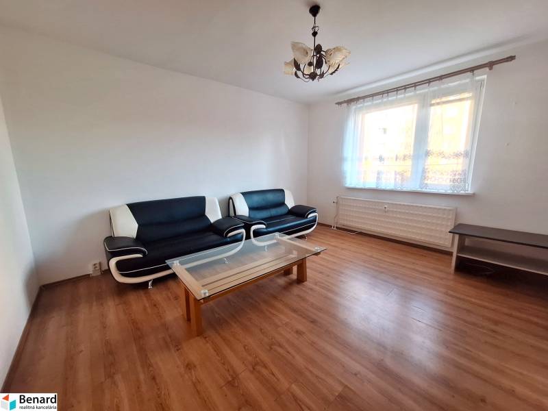 Living room in a 3-room apartment with sofas, a coffee table, and a wooden decor floor.
