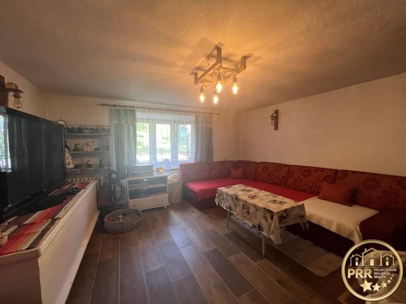 Living room and cottage with traditional furniture, sofa, and wooden floor for relaxation.