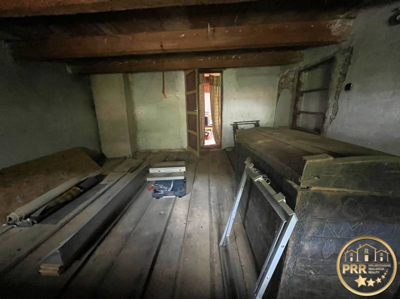 The cottage offers a cozy, traditional interior with a wooden ceiling and floor.