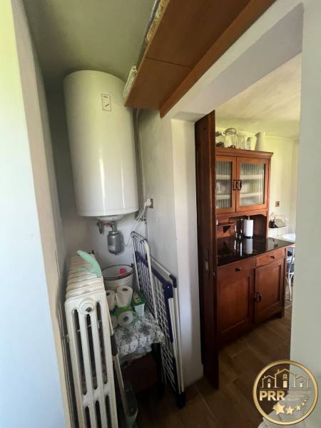 A cottage with a wooden decor floor, a boiler, and storage space in Šípkov.